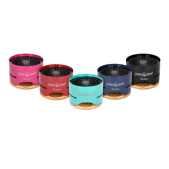 Row of five compact tabletop charcoal grills in pink, red, turquoise, blue, and black finishes with wooden bases, designed for small outdoor cooking, featured in Farm, Garden & Tool and Grilling collections.