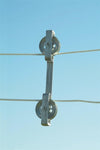 Rust-proof cast aluminum clothesline spacer with pulley wheels keeping two parallel clotheslines evenly separated against a clear blue sky, ideal for Home & Decor and Laundry Supplies collections.