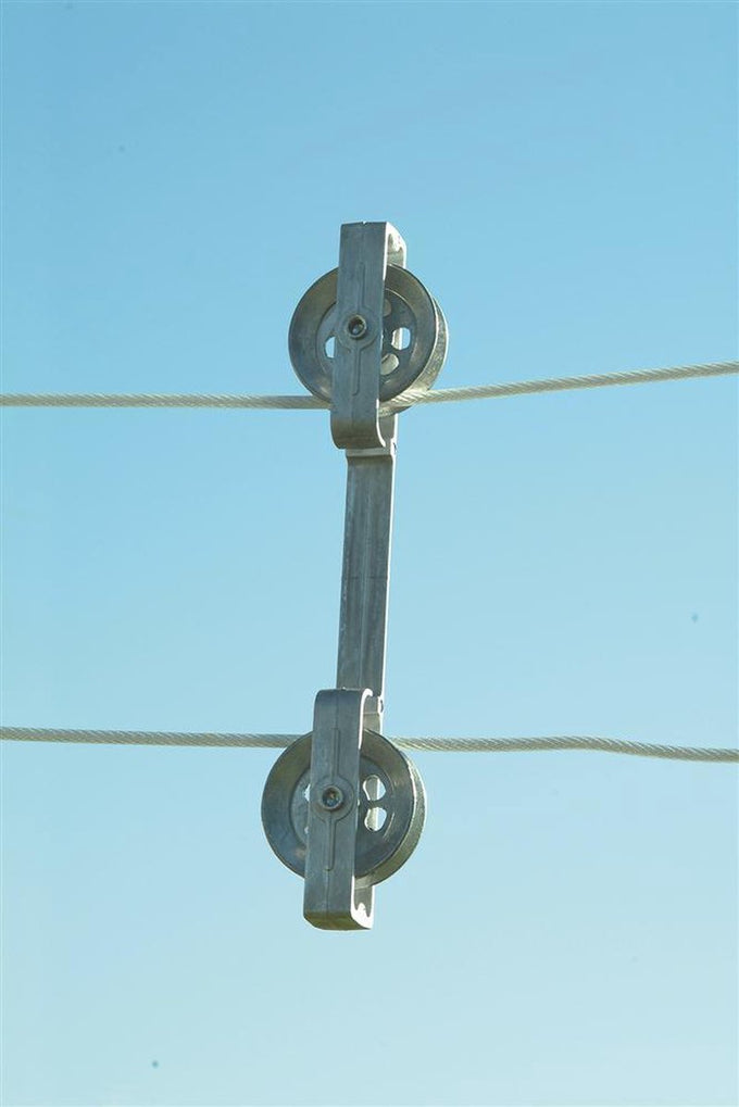 Rust-proof cast aluminum clothesline spacer with pulley wheels keeping two parallel clotheslines evenly separated against a clear blue sky, ideal for Home & Decor and Laundry Supplies collections.