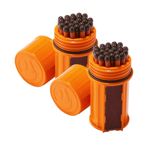 Two orange waterproof containers each filled with tightly packed brown-headed matches and equipped with built-in striking surfaces, designed for reliable outdoor use in camping and emergency supplies.