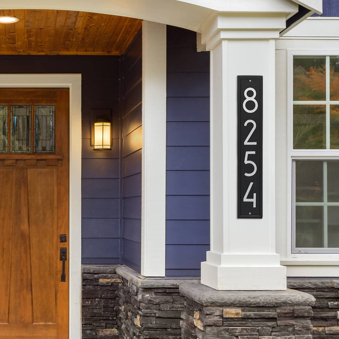 Handcrafted vertical black and silver address plaque with modern numbers mounted on a white porch column, enhancing curb appeal, made in USA, featured in Home & Decor and Mailboxes and Address Signs collections.