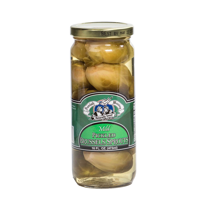Clear glass jar of handcrafted mild pickled Brussels sprouts in light brine with a green label and gold lid, made in USA, featured in Kitchen & Food, Pantry, Best Sellers, and Promo Eligible collections.