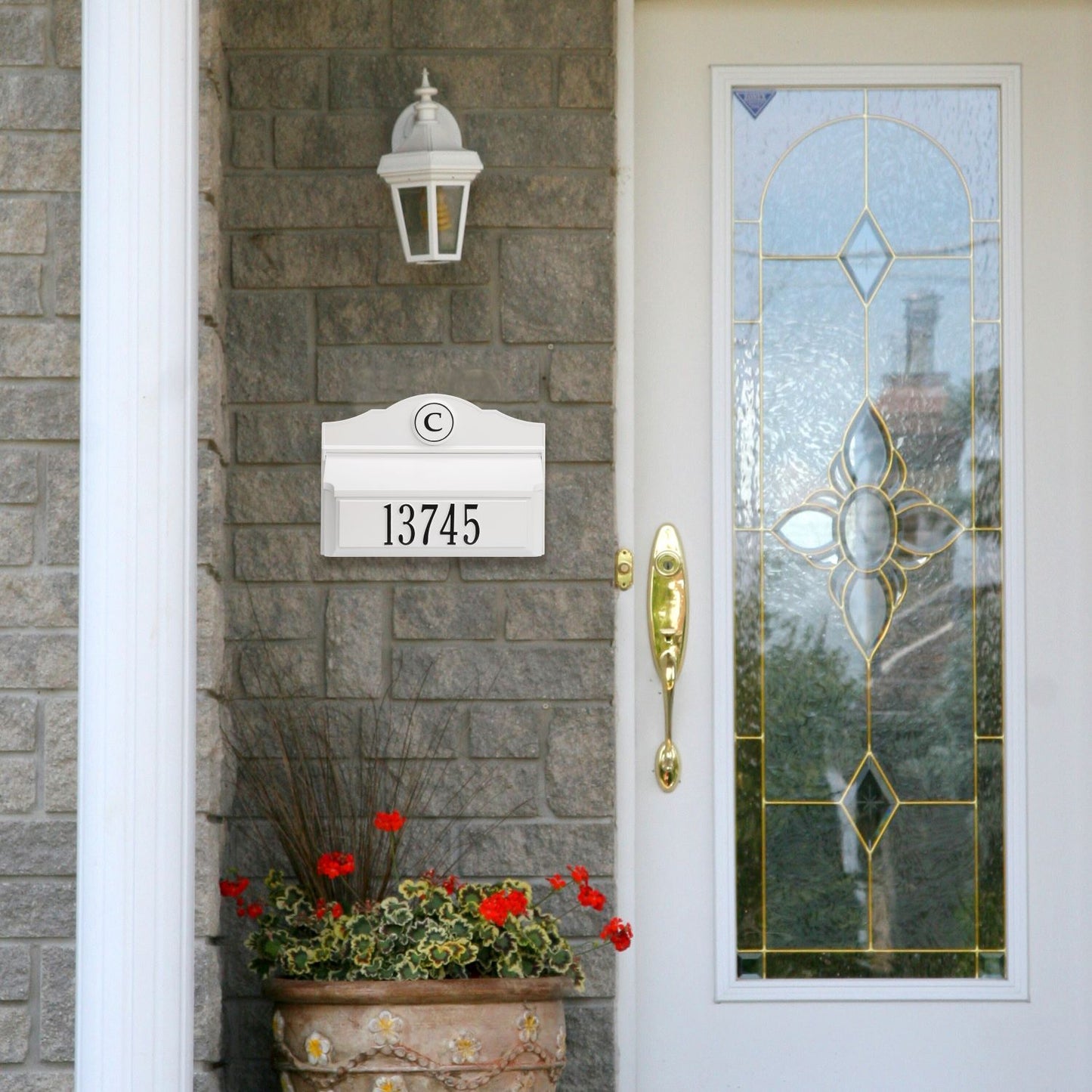 White and black handcrafted wall mount mailbox with personalized monogram and house number, installed on gray brick exterior alongside decorative glass front door, featured in Home & Decor, Mailboxes and Address Signs, USA Made, and Best Sellers collections.