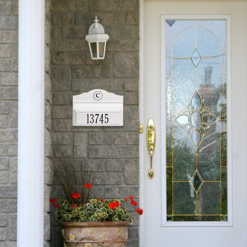 White and black handcrafted wall mount mailbox with personalized monogram and house number, installed on gray brick exterior alongside decorative glass front door, featured in Home & Decor, Mailboxes and Address Signs, USA Made, and Best Sellers collections.