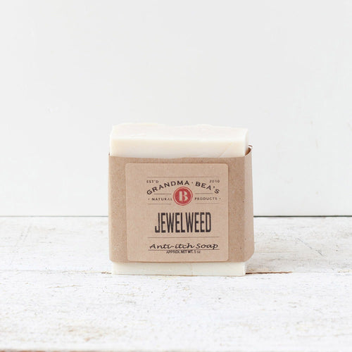 Bar of handmade jewelweed anti-itch soap wrapped in simple brown paper packaging, featured in Health & Wellness, Soaps, and USA Made collections.