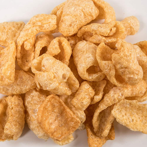 Close-up of crispy, golden pork rinds with an airy texture, handcrafted and made in USA, featured in Kitchen & Food, Food, Snacks and Sweets, USA Made, Best Sellers, and Promo Eligible collections.