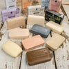 Assorted handcrafted bars featuring natural ingredients and embossed branding from a USA-made soap collection, ideal for Health & Wellness, Grooming, and Soapmaking enthusiasts.