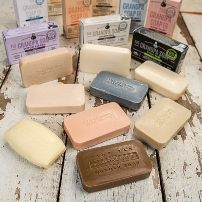 Assorted handcrafted bars featuring natural ingredients and embossed branding from a USA-made soap collection, ideal for Health & Wellness, Grooming, and Soapmaking enthusiasts.