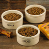 Pair of small handcrafted stoneware pet bowls in natural stone color with clear "Dog" and "Kitty" labels, filled with kibble, featured in Home & Decor, Pet Supplies, USA Made collections.