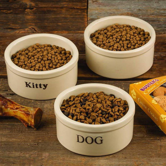 Pair of small handcrafted stoneware pet bowls in natural stone color with clear "Dog" and "Kitty" labels, filled with kibble, featured in Home & Decor, Pet Supplies, USA Made collections.