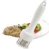 White plastic-handled meat tenderizer with 24 stainless-steel prongs positioned on a plate next to seasoned cooked poultry, part of Kitchen Gadgets and Butchering Supplies collections.