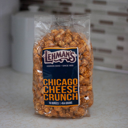 Clear bag of handcrafted caramel popcorn with Chicago cheese crunch flavor, a unique sweet and savory snack made in USA, ideal for Kitchen & Food, Snacks and Sweets, Popcorn, USA Made, Best Sellers, and Promo Eligible collections.