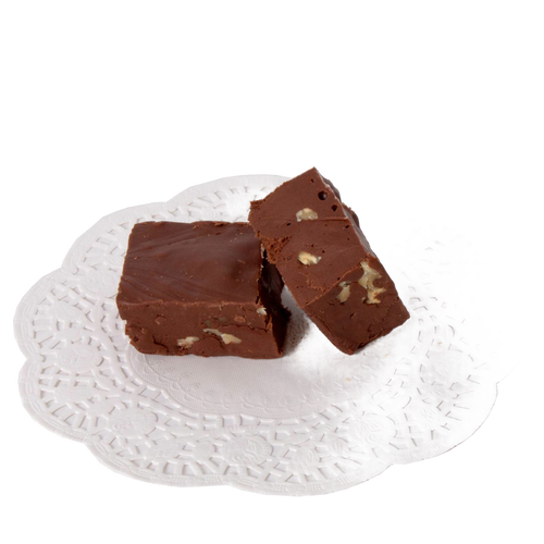 Two pieces of creamy chocolate fudge with visible nut pieces, presented on a decorative white paper doily, showcasing a handcrafted treat from USA-made snack collections.