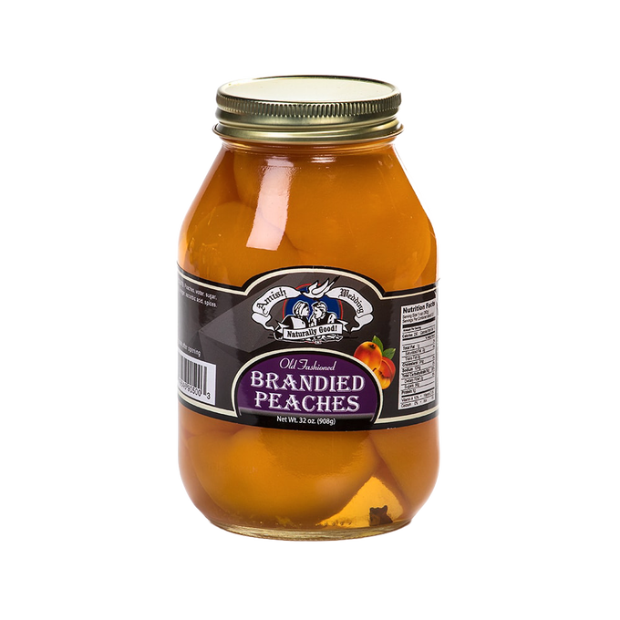Glass jar of old-fashioned brandied peaches with a metal lid, showcasing preserved fruit in syrup, featured in Kitchen & Food, Food, Pantry, USA Made, Best Sellers, Promo Eligible collections.