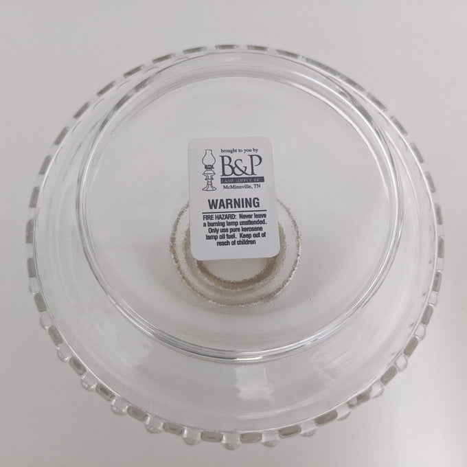 Clear glass lamp font with a scalloped edge, featuring a central wick holder, crafted for use in lamps & lighting, oil lamps, wall lamps, and popular best sellers collections.