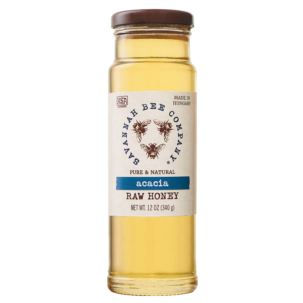Clear glass jar of pale golden acacia raw honey with a brown lid and natural label featuring bees, ideal for Pantry and Kitchen & Food collections in Best Sellers and Sale.