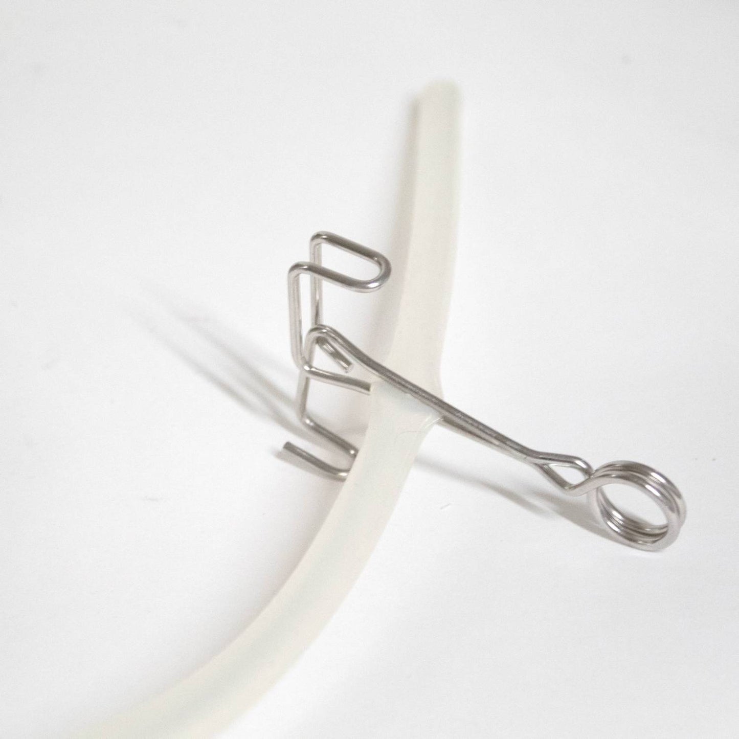 Stainless steel clip securing flexible clear tubing, designed for use with steam juicers in Kitchen & Food, Juicers and Steamers, Best Sellers, and Promo Eligible collections.