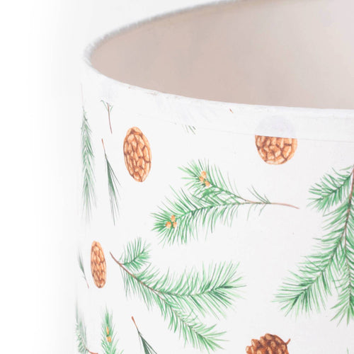 Close-up of a parchment lamp shade decorated with pine bough and pinecone illustrations, designed for a warm, rustic ambiance in Lamps & Lighting and Lamp Shades collections.