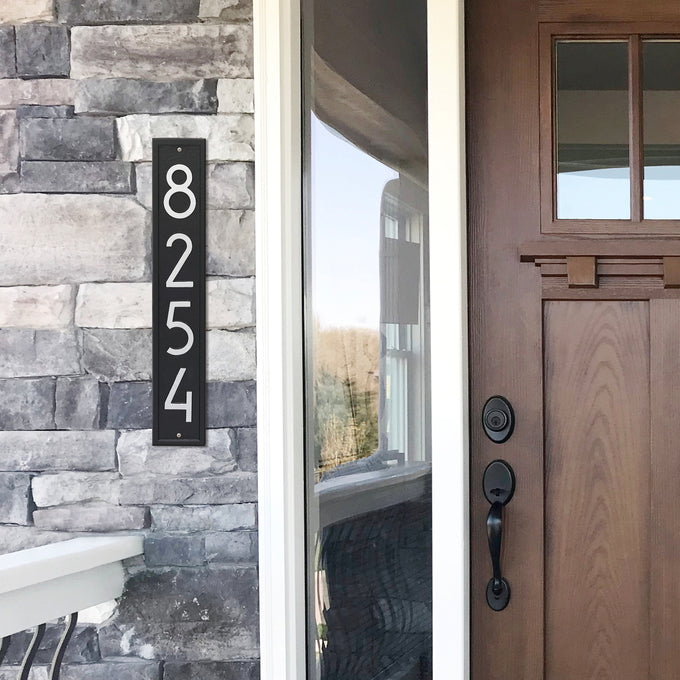 Handcrafted vertical black and silver wall plaque displaying modern house numbers on a stone exterior, enhancing curb appeal for Home & Decor, USA Made, and Mailboxes and Address Signs collections.