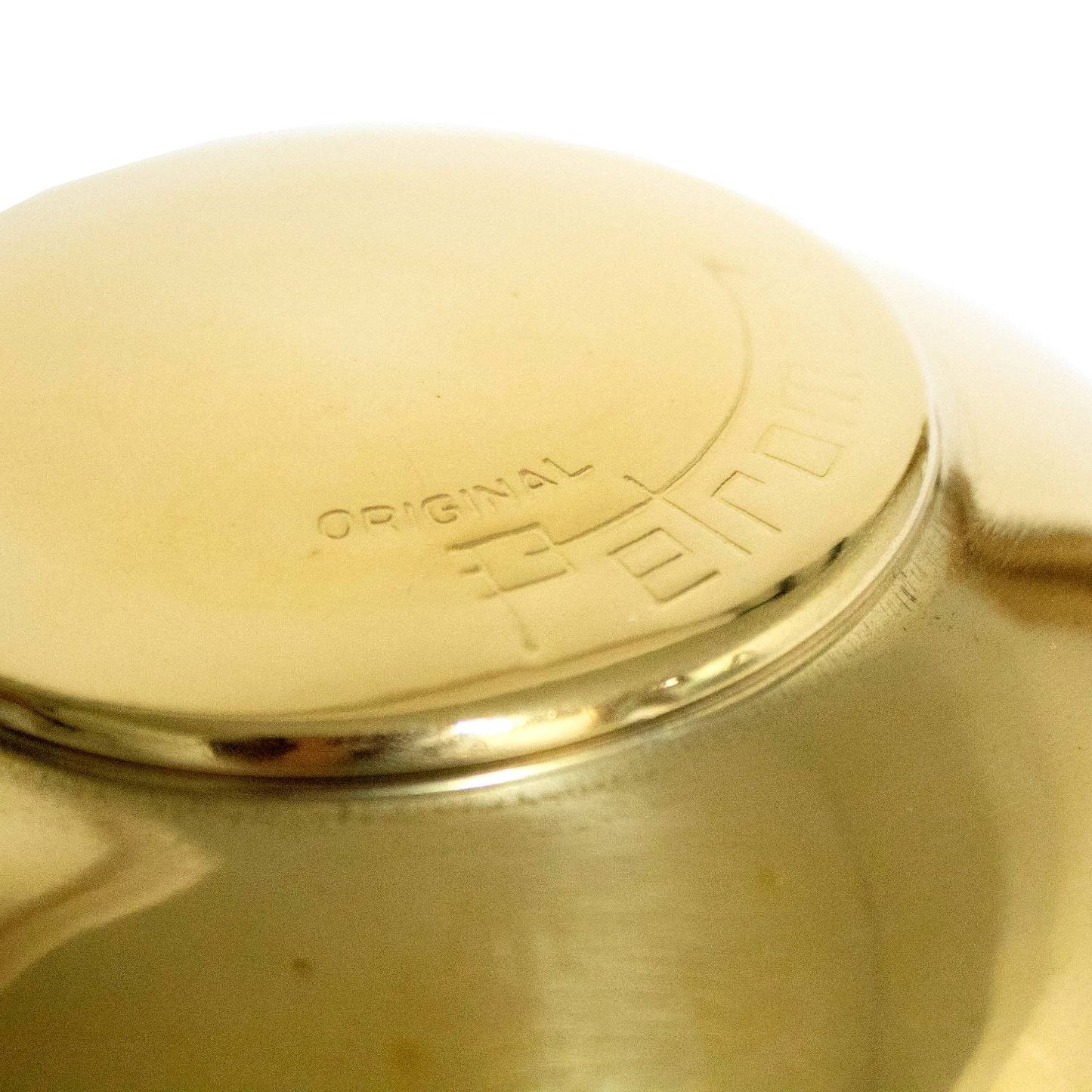 Close-up of a polished brass Petromax lamp hood featuring embossed branding, ventilation holes around the edge, designed for HK350 and HK500 models, featured in Lamps & Lighting and Parts and Accessories collections.