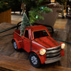 Small handcrafted red metal vintage-style holiday truck with battery-operated illuminated headlights and festive green tree in its bed, ideal for Home & Decor and Holiday Decor.