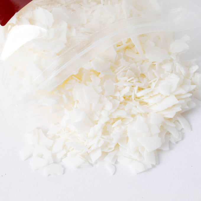Close-up of all-natural soy wax pellets spilling from a clear resealable bag, ideal for candle making, featured in Lamps & Lighting, Candles and Candlemaking, and Promo Eligible collections.