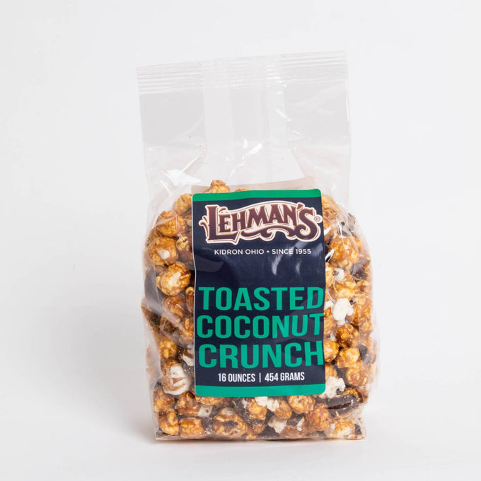 Clear bag of handcrafted toasted coconut caramel popcorn crunch with chocolate pieces, made in USA, featured in Kitchen & Food, Snacks and Sweets, Popcorn, USA Made, and Best Sellers collections.
