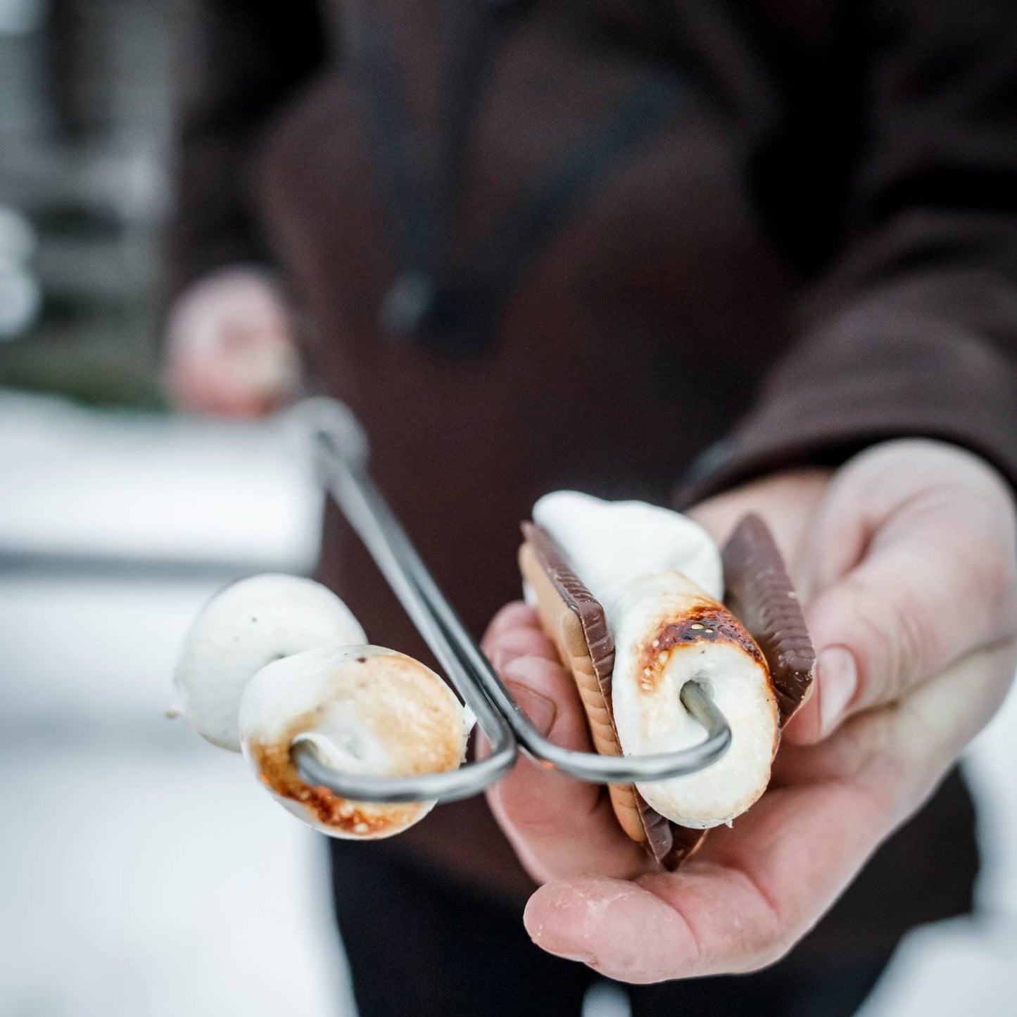 Handcrafted adjustable campfire skewer with a wooden handle roasting marshmallows and melting chocolate for s’mores, ideal for Farm, Garden & Tool, Camping, Best Sellers, and Promo Eligible collections.