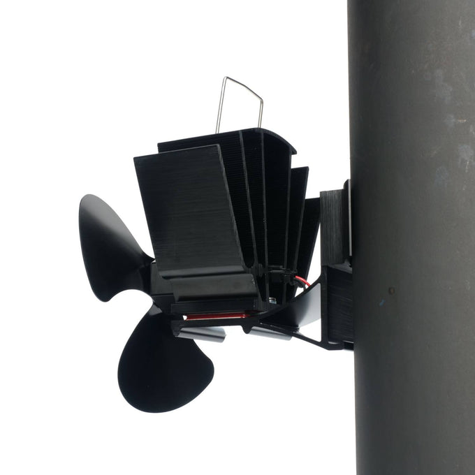 Black heat-activated magnetic fan with three blades mounted on a stove flue pipe, designed to circulate warm air efficiently; featured in Stoves, Hearth Accessories, Best Sellers, Promo Eligible collections.