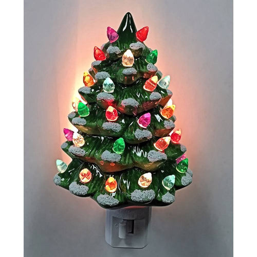 Handcrafted ceramic Christmas tree nightlight with multicolored bulbs and painted snow accents, providing a warm, festive glow for holiday decor and home collections.