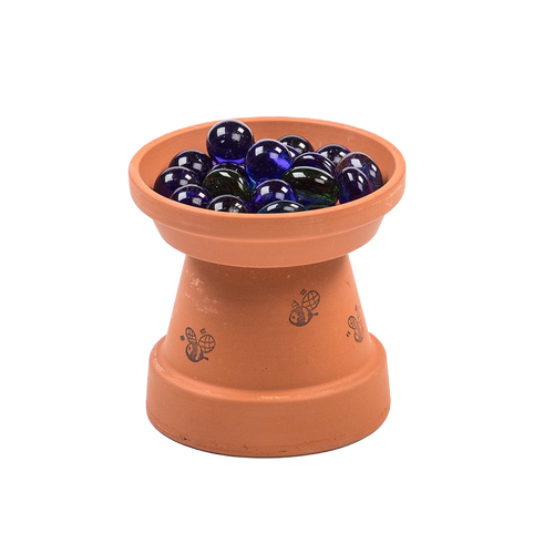 Handcrafted terracotta bee bath with bee illustrations, featuring blue glass stones for safe landing spots, designed for garden and animal care use in the USA.