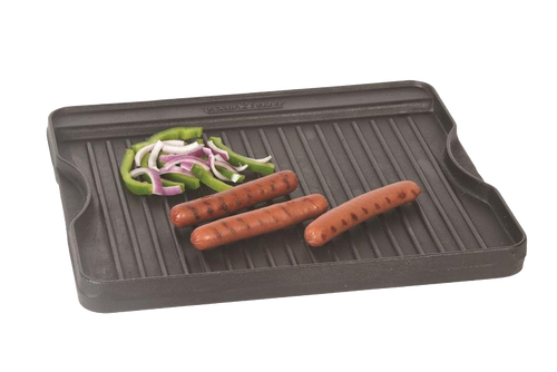 Small cast iron grill with ridged cooking surface holding grilled hot dogs and sliced green bell peppers and onions, ideal for Kitchen & Food and Cast Iron cookware collections.