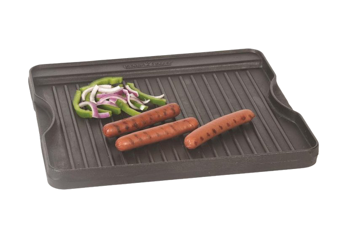 Small cast iron grill with ridged cooking surface holding grilled hot dogs and sliced green bell peppers and onions, ideal for Kitchen & Food and Cast Iron cookware collections.