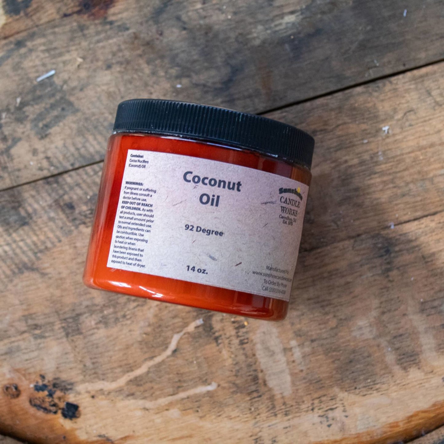 Amber jar of handcrafted coconut oil at 92 degrees with a black lid, 14 oz size, designed for soapmaking and featured in Health & Wellness, Soapmaking Supplies, and USA Made collections.