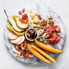 Round polished marble serving tray with a smooth surface, featuring an assortment of snacks arranged for elegant presentation, ideal for Kitchen & Food and Dinnerware collections.