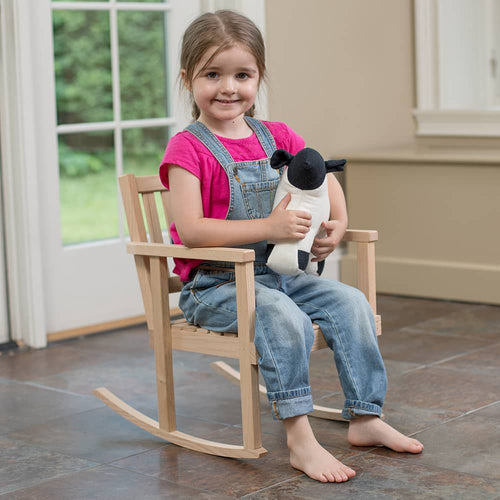 Young girl sitting barefoot on a handcrafted wooden children's rocker made of unfinished oak, holding a stuffed animal, in a bright room with natural light, suitable for Toys, Books & Games, USA Made, Amish Made, Children's Toys, Wooden Toys, Best Sellers, and Promo Eligible collections.