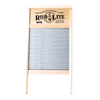 Handcrafted galvanized spiral washboard with wooden frame and decorative printed nameplate, designed for effective stain removal and included in USA-made laundry supplies collections.