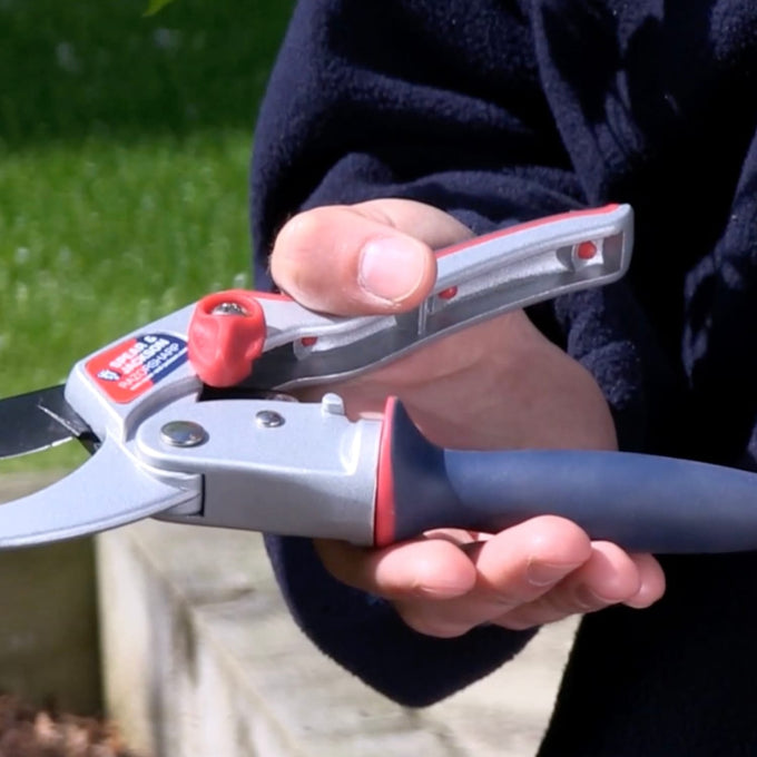 Hand gripping ratchet anvil pruners with ergonomic twist handle and cushioned grip, designed for cutting thick woody stems, featured in Farm, Garden & Tool and Best Sellers collections.