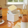 Square porcelain butter keeper with lid holding a half cup of soft butter, handcrafted for countertop use in Kitchen & Food, Specialty Equipment, and Storage collections.