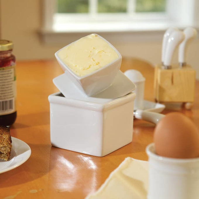 Square porcelain butter keeper with lid holding a half cup of soft butter, handcrafted for countertop use in Kitchen & Food, Specialty Equipment, and Storage collections.