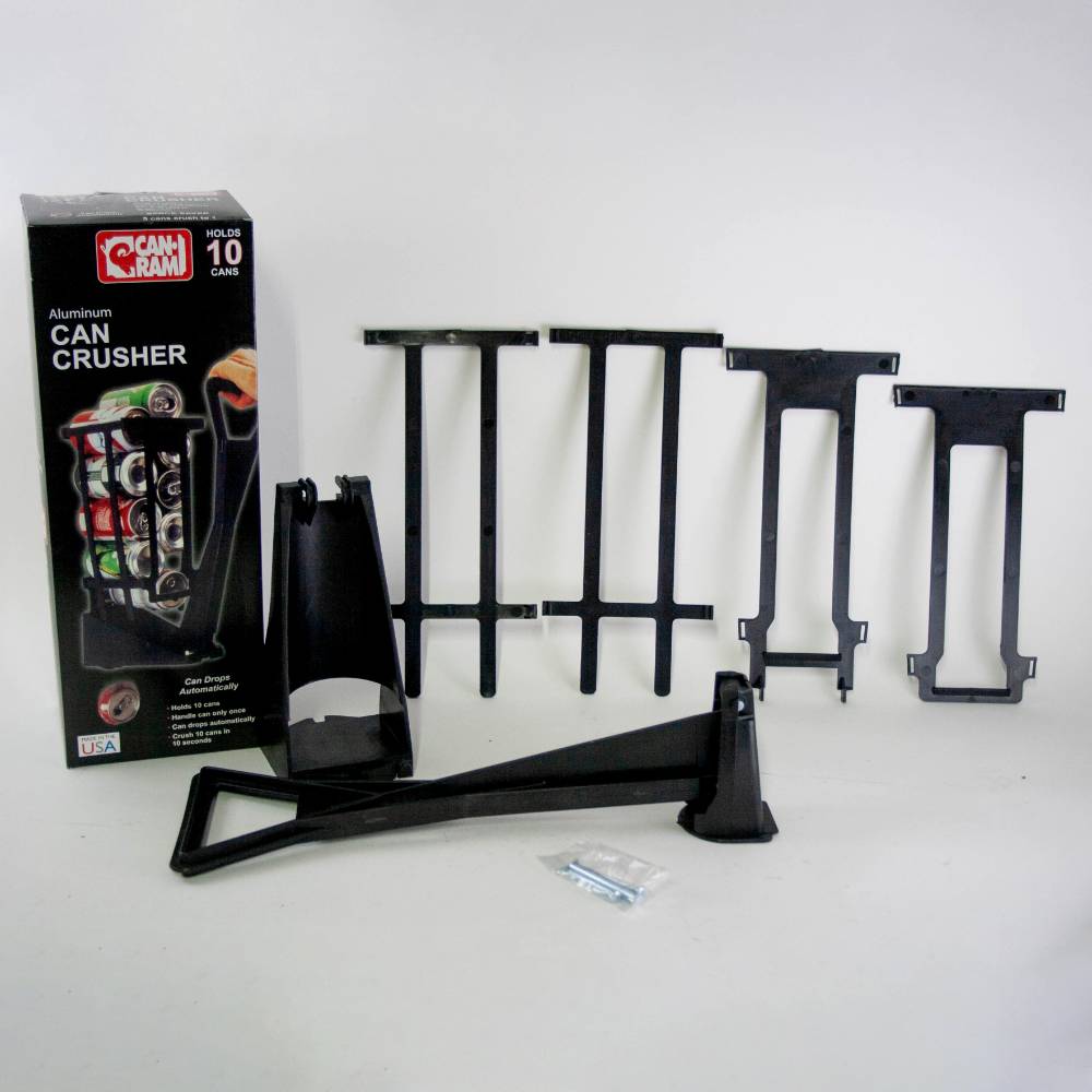 Components of a heavy-duty black plastic can crusher including a large lever, support brackets, mounting hardware, and product packaging, featured in Home & Decor, Household Helpers, USA Made, Best Sellers, and Promo Eligible collections.