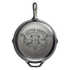 Bottom view of a handcrafted cast iron skillet featuring a detailed embossed design with a steer skull and rope motif, made in USA, ideal for Kitchen & Food and Cookware collections.