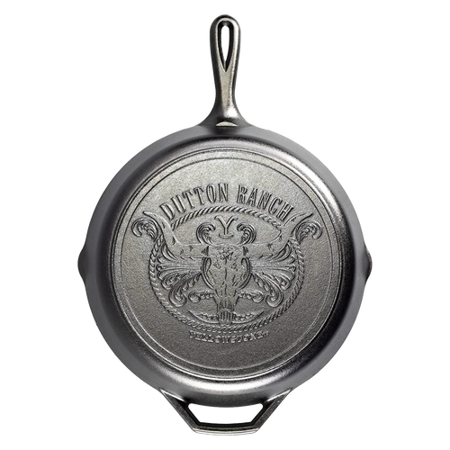 Bottom view of a handcrafted cast iron skillet featuring a detailed embossed design with a steer skull and rope motif, made in USA, ideal for Kitchen & Food and Cookware collections.