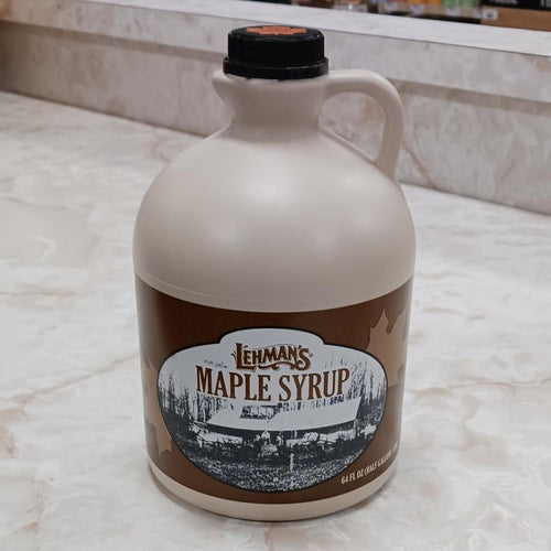 Handcrafted beige jug of amber maple syrup with classic brown label featuring vintage maple sugaring scene, ideal for Kitchen & Food, Pantry, USA Made, Best Sellers, and Promo Eligible collections.