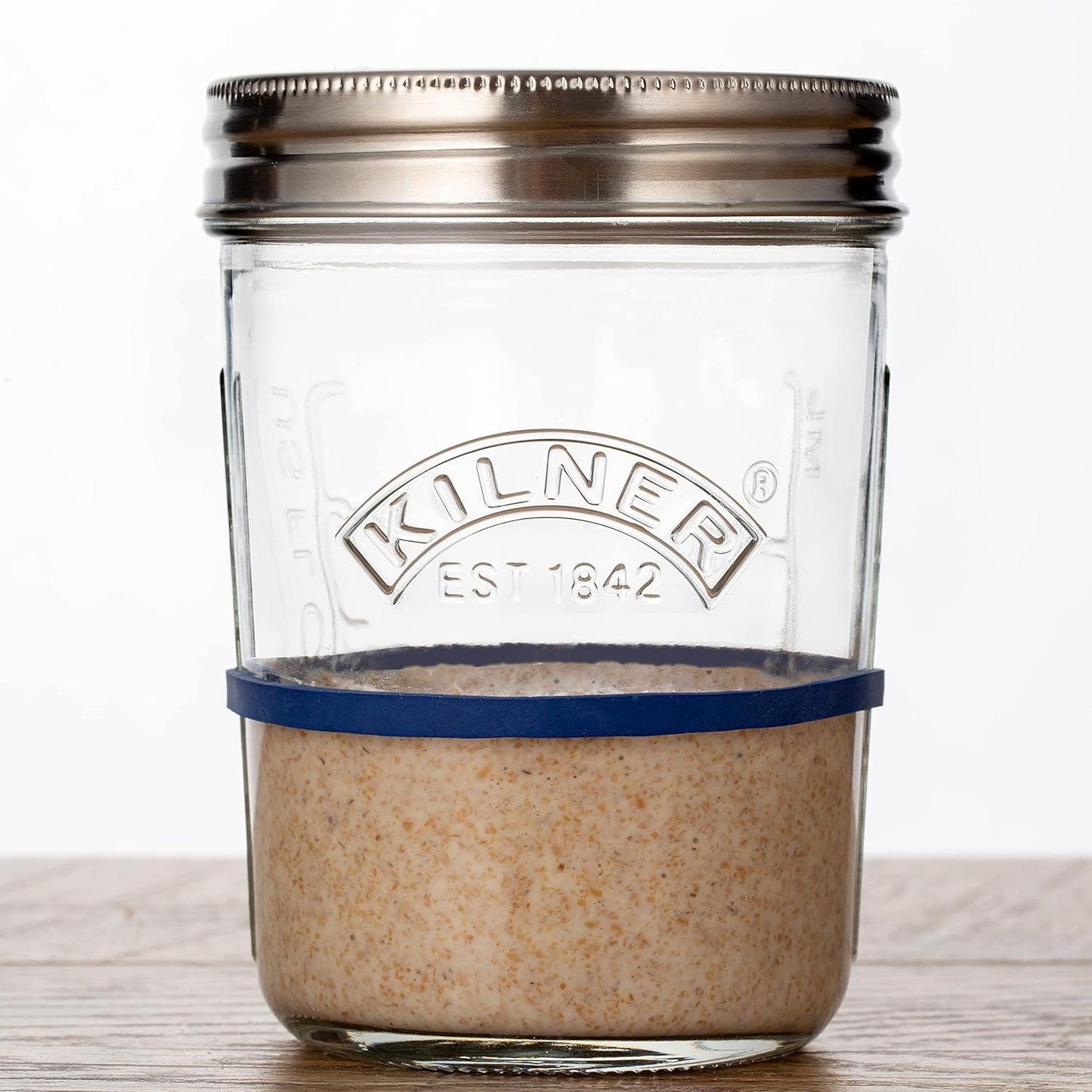 Handcrafted Kilner glass jar with metal lid and blue silicone band containing active sourdough starter, ideal for Kitchen & Food, Baking Supplies, and Storage collections.