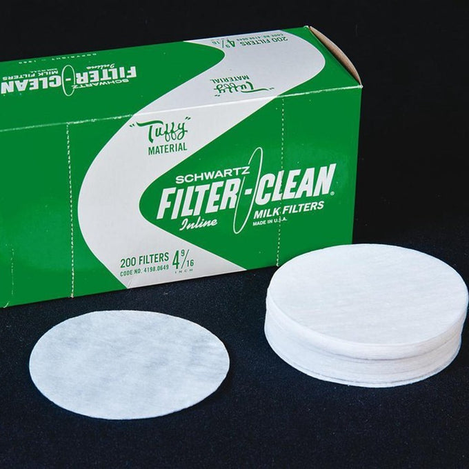 Stack of handcrafted white Fast-Flo filter disks for small milk strainers made with Tuff material beside green vintage-style packaging, featured in Farm, Garden & Tool and Animal Care collections.