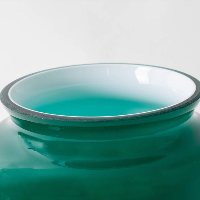 Close-up of a handcrafted emerald glass lamp shade with smooth edges, designed for Aladdin hanging lamps, featured in Lamps & Lighting and Parts and Accessories collections.