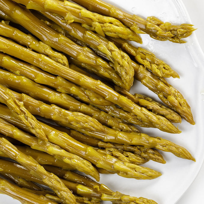 Close-up of tangy pickled asparagus spears with a vibrant green hue, showcasing handcrafted, Amish-made quality, perfect for Kitchen & Food, Pantry, and USA Made collections.