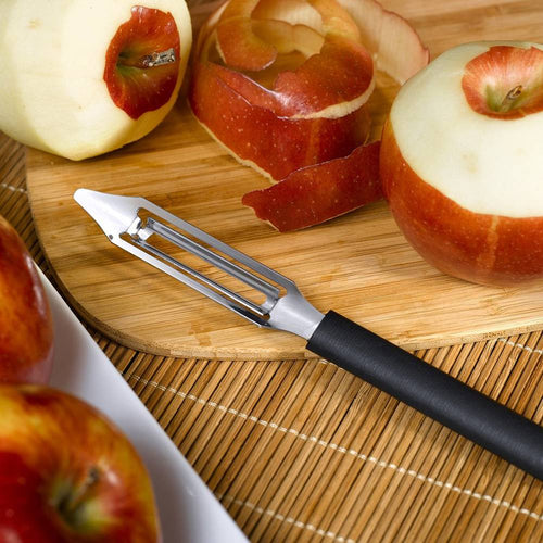 Handcrafted vegetable peeler with razor-sharp stainless steel blade and durable black resin handle peeling apples on a wooden cutting board, ideal for Kitchen & Food, Specialty Equipment, Peelers and Pitters, USA Made, Best Sellers, Promo Eligible collections.