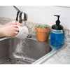 Hand using water to rinse a white ceramic mug over a stainless steel sink next to a regular-mouth mason jar soap pump filled with blue liquid soap, set on a granite countertop with a small potted plant nearby, ideal for Health & Wellness and Home & Decor collections.